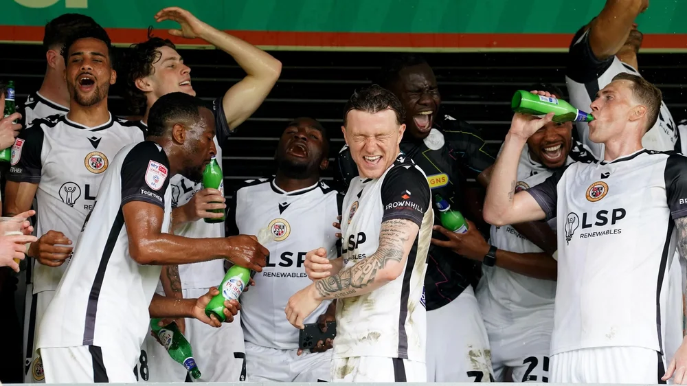 Bromley players celebrate after the final game of the season